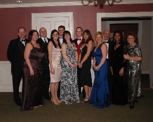 Dave Judson, 2009 chapter president, and Dave Hart, current chapter president, pose with the 2010 Valentine's Ball committee. The event raised $14,000 for the chapter scholarship fund.